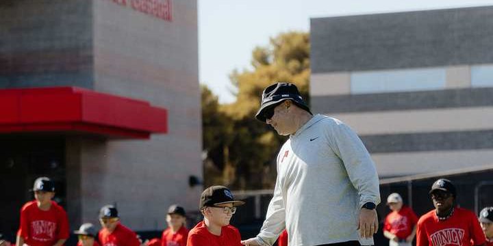 Young baseball campers with a coach at UNLV