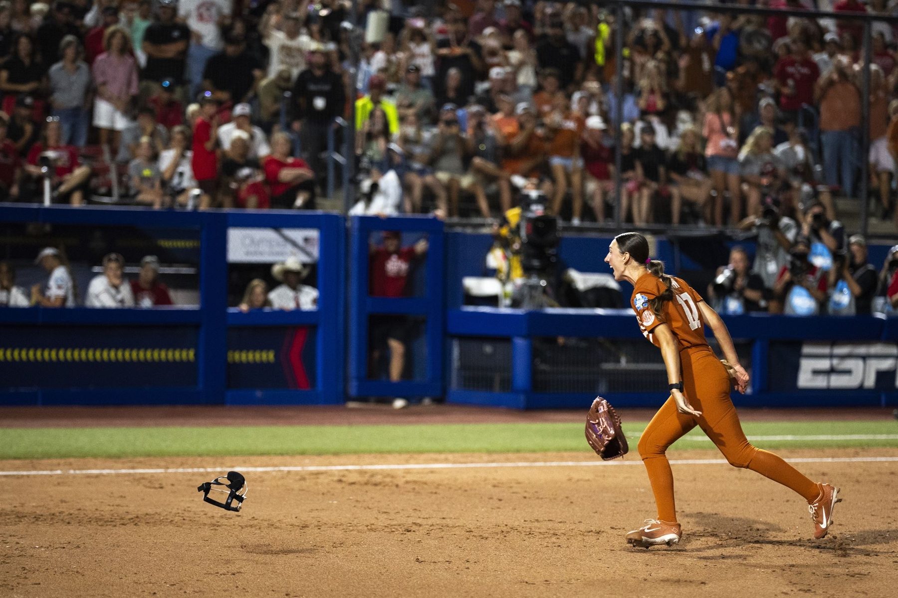 Teagan tossing her mask and celebrating the final out
