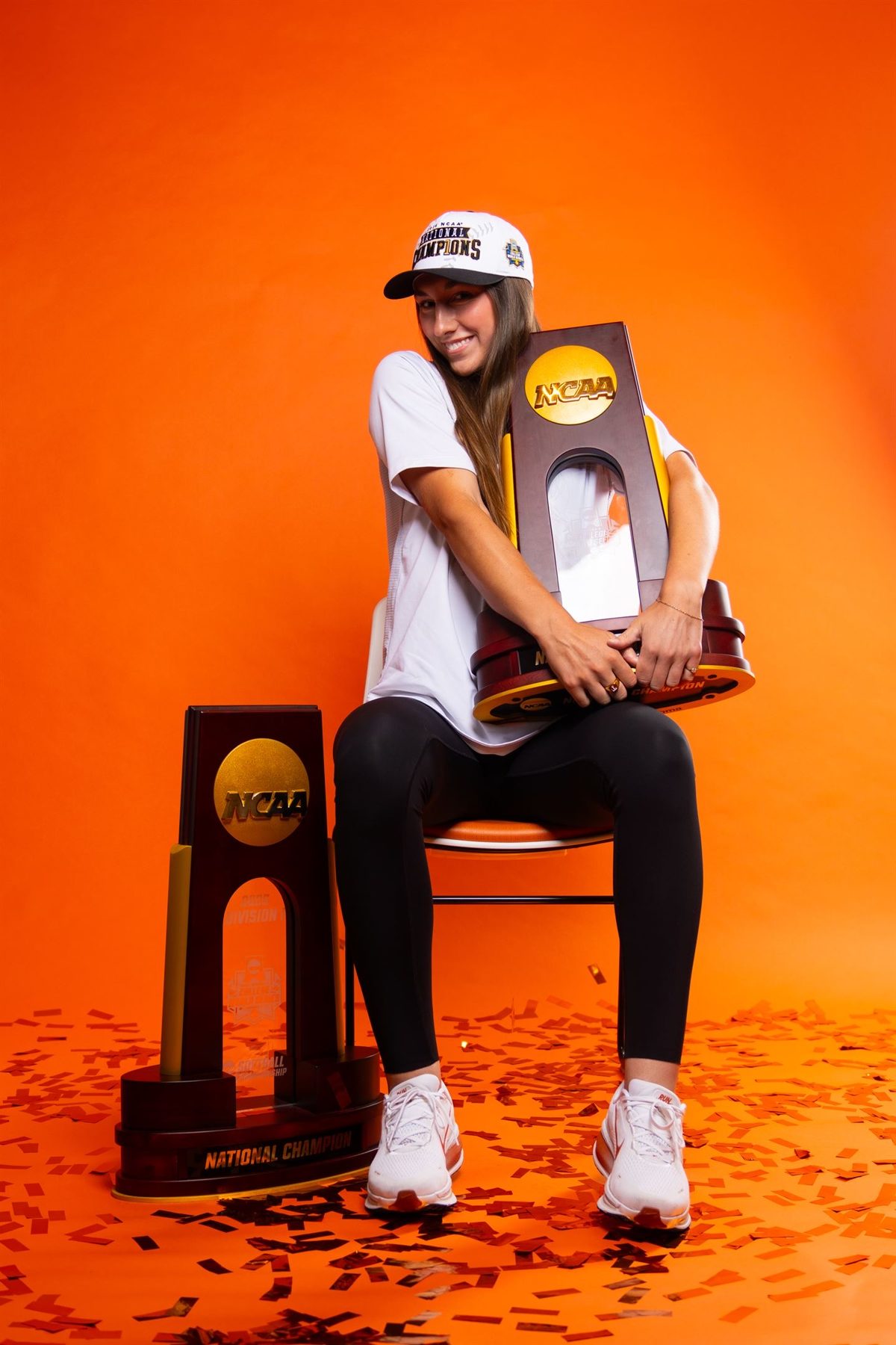 Teagan Kavan hugging the NCAA national championship trophy in a studio portrait
